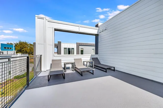 a backyard of a house with table and chairs