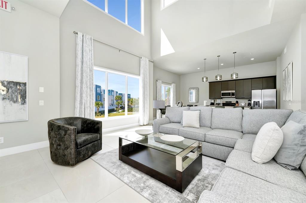 7740 Sandy Ridge Drive, Unit 220 Reunion, FL 34747 - Photo 5 of 55 a living room with furniture and a large window