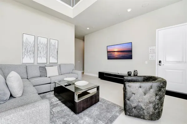 a living room with furniture and large windows