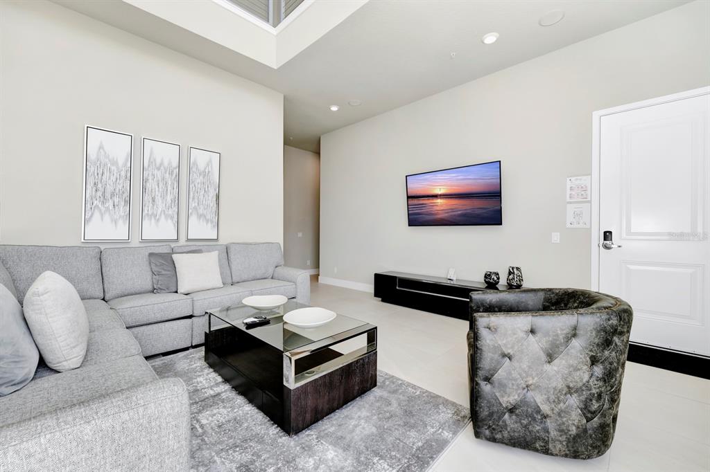 7740 Sandy Ridge Drive, Unit 220 Reunion, FL 34747 - Photo 7 of 55 a living room with furniture and large windows