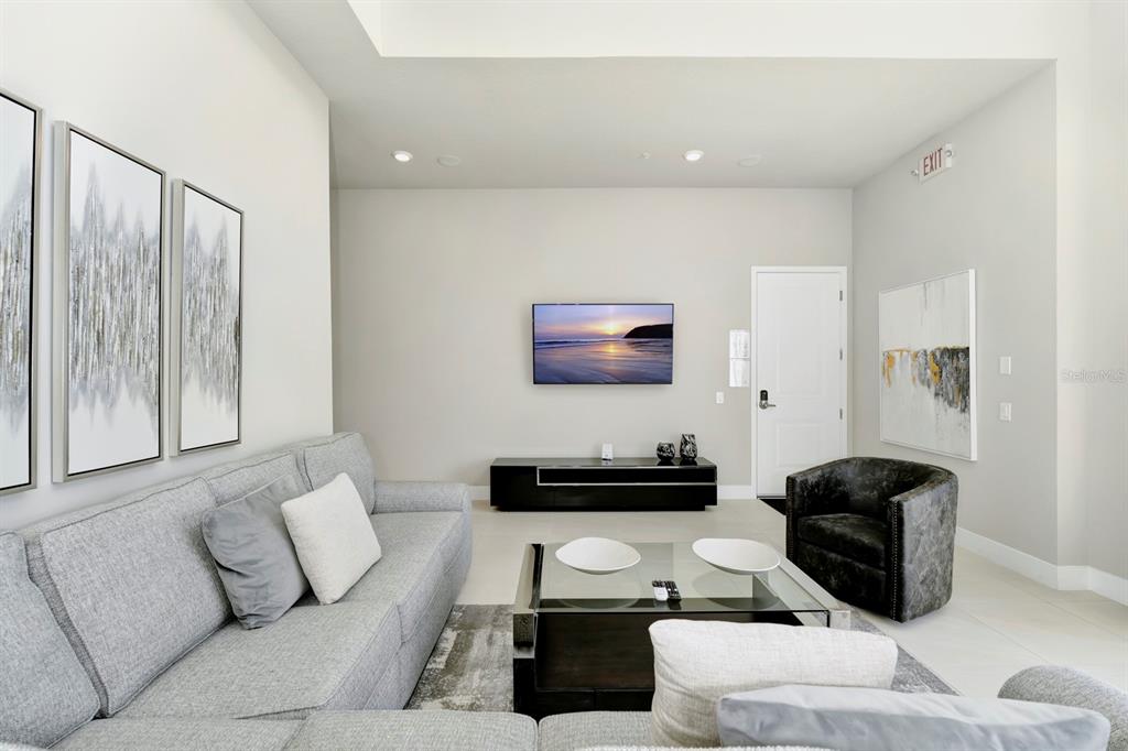 7740 Sandy Ridge Drive, Unit 220 Reunion, FL 34747 - Photo 8 of 55 a living room with furniture and a flat screen tv