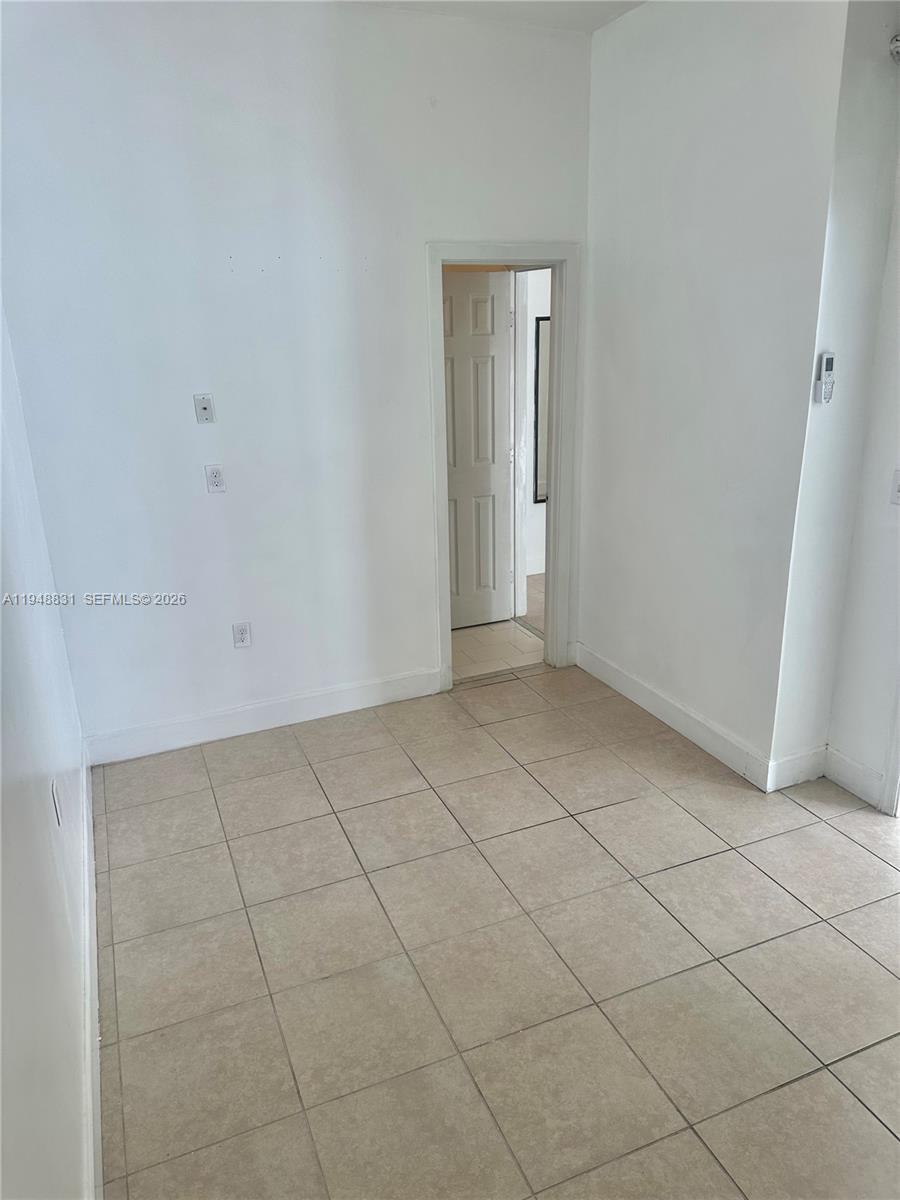 27583 Southwest 133rd Avenue, Unit 2 Homestead, FL 33032 - Photo 6 of 7 a view of an empty room and window