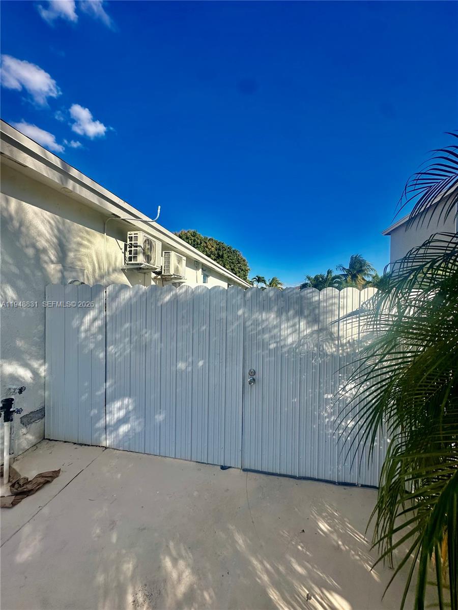 27583 Southwest 133rd Avenue, Unit 2 Homestead, FL 33032 - Photo 7 of 7 a view of a street with wooden fence
