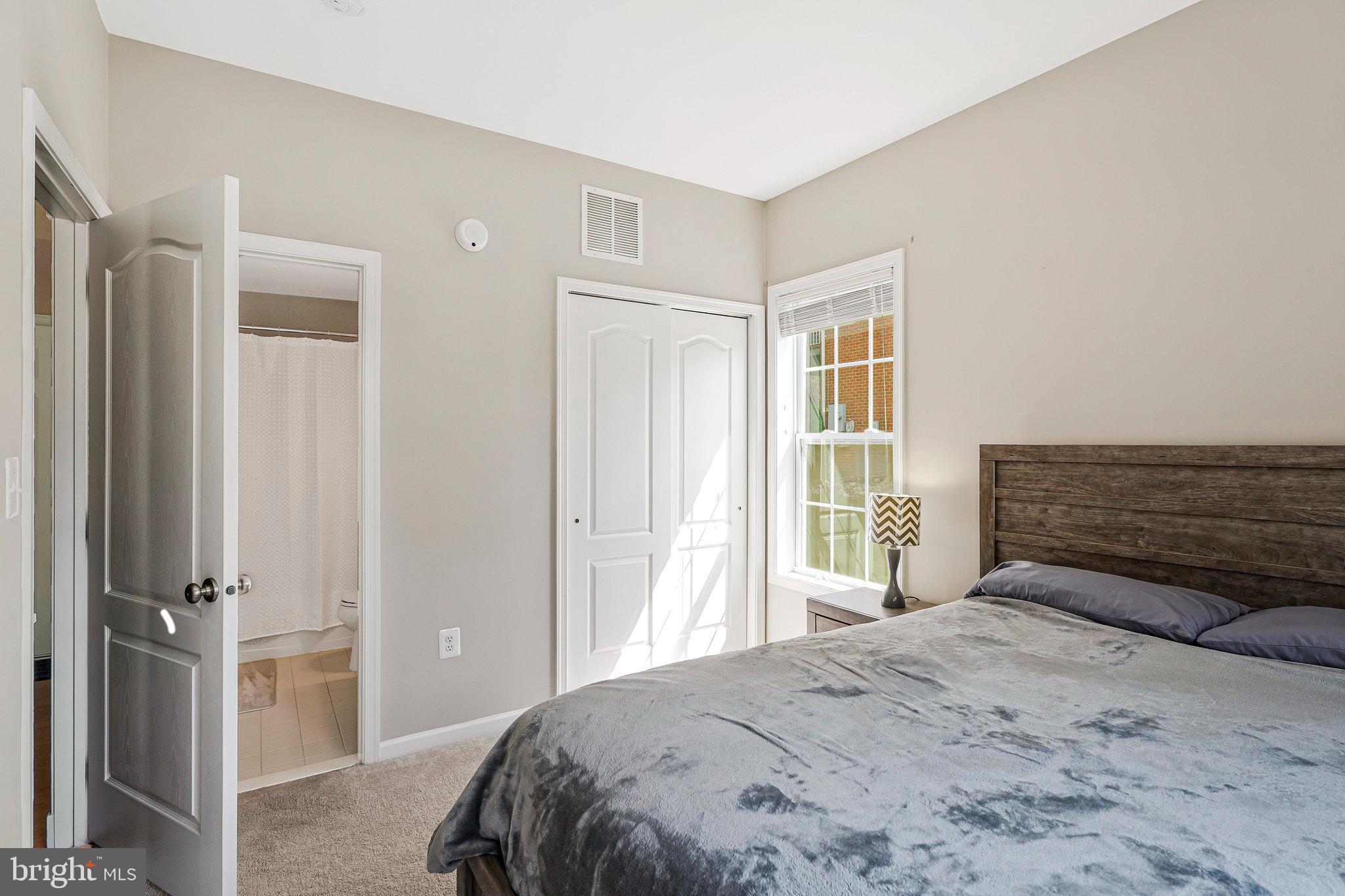 23073 Weybridge Square Broadlands, VA 20148 - Photo 12 of 24 a bedroom with a bed and a window