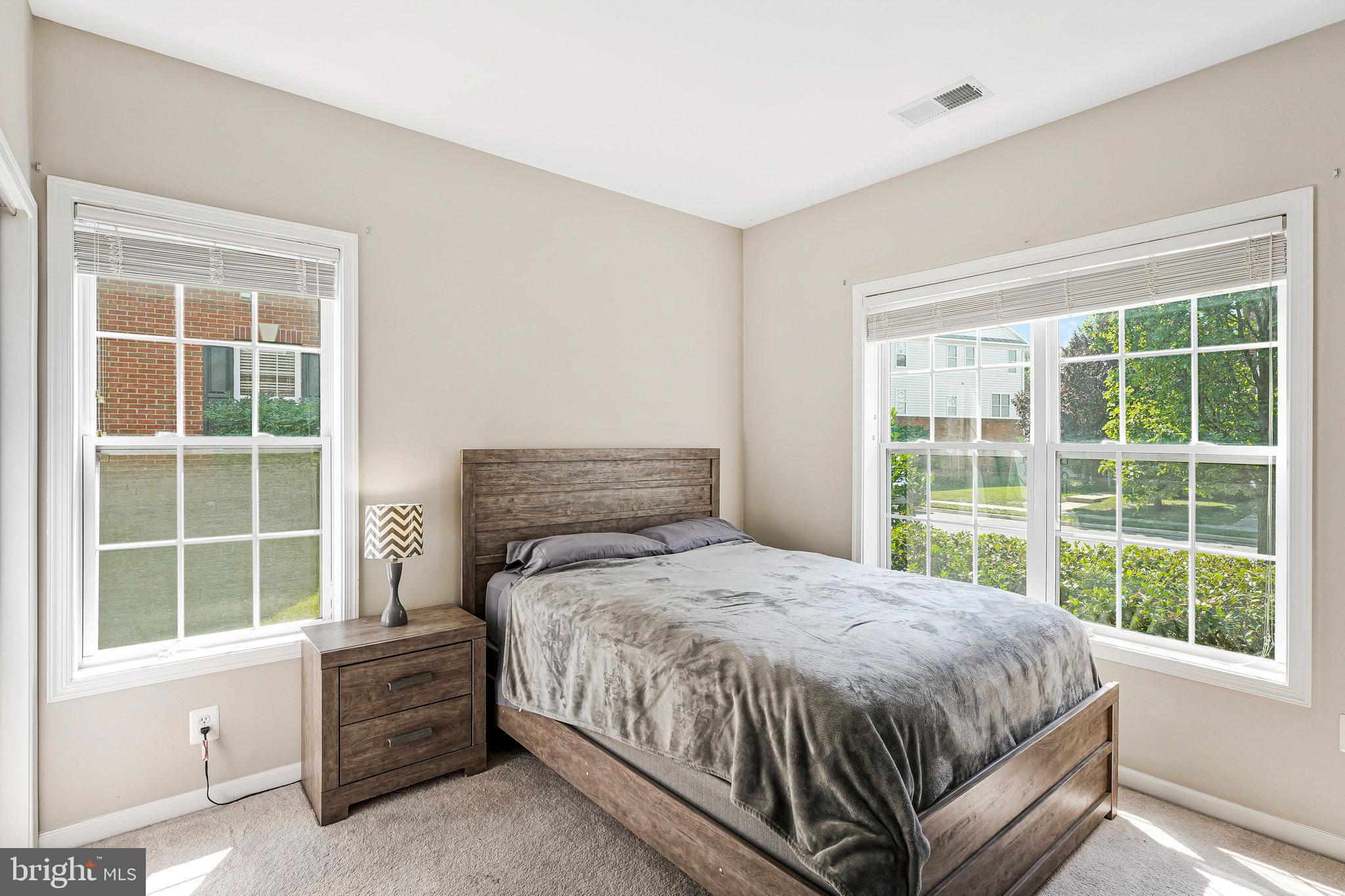 23073 Weybridge Square Broadlands, VA 20148 - Photo 14 of 24 a bedroom with a bed and a window
