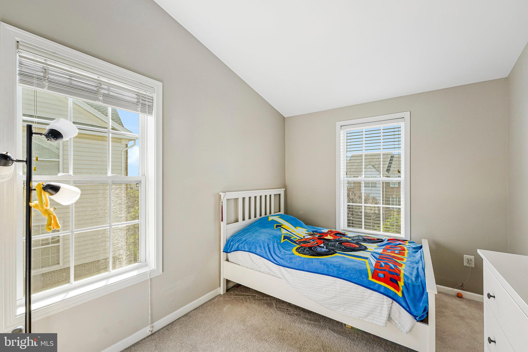 23073 Weybridge Square Broadlands, VA 20148 - Photo 15 of 24 a bedroom with a bed and a window