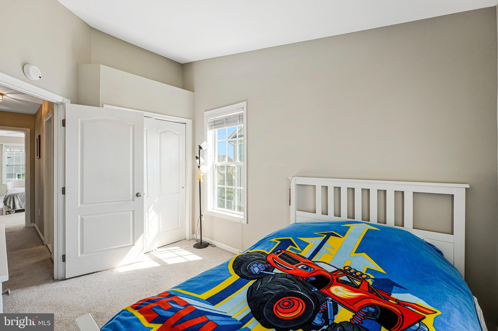 23073 Weybridge Square Broadlands, VA 20148 - Photo 16 of 24 a bedroom with a bed and a window