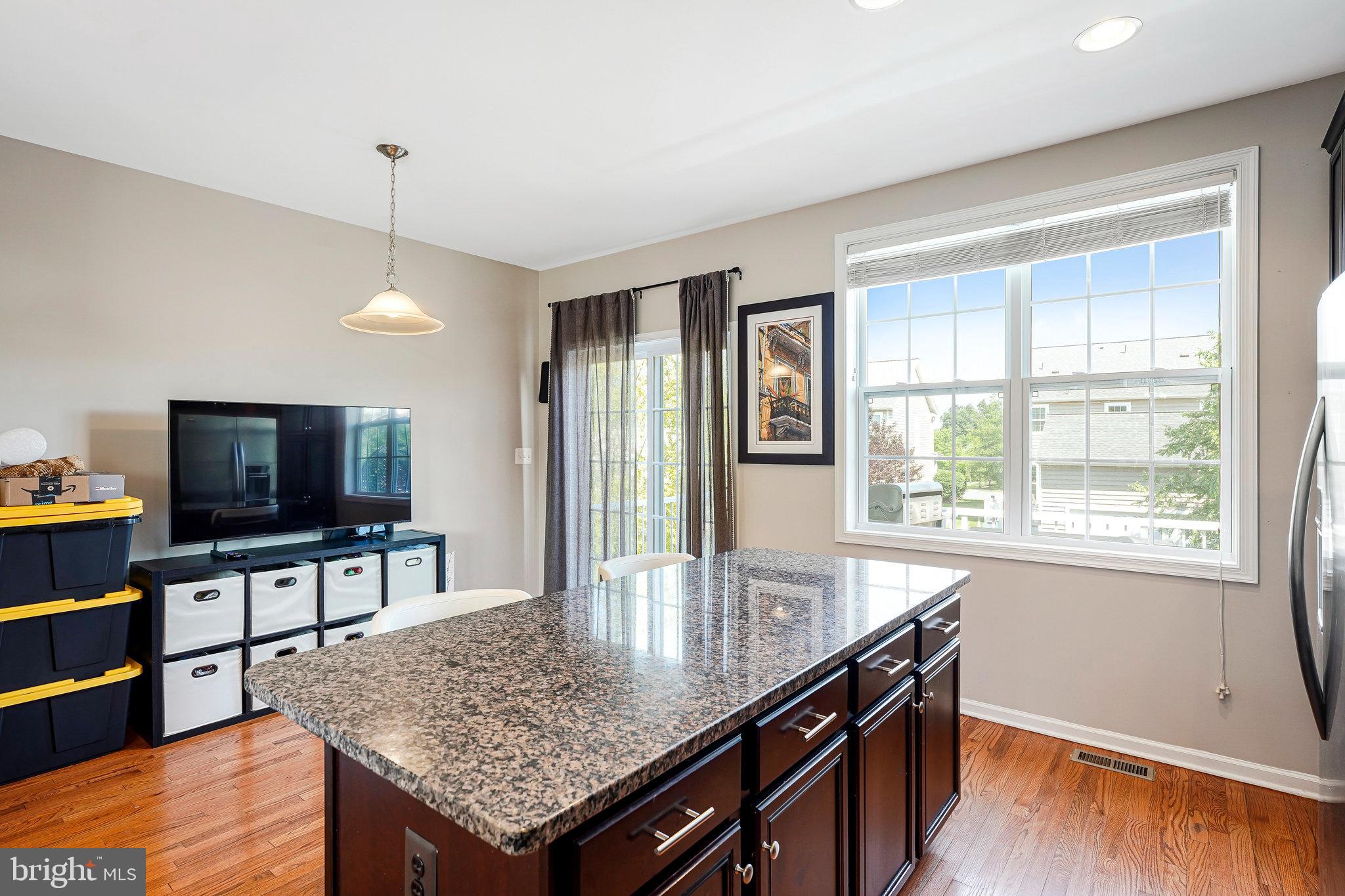 23073 Weybridge Square Broadlands, VA 20148 - Photo 9 of 24 a kitchen with a counter space and wooden floor