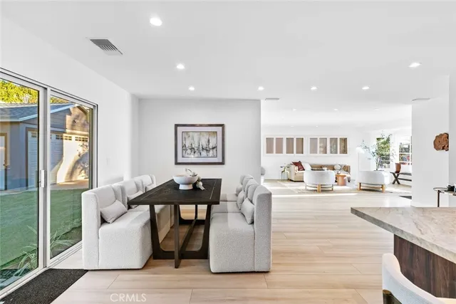a kitchen with kitchen island granite countertop a sink stove and refrigerator