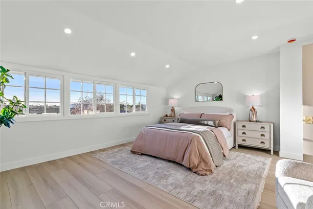 a view of a backyard with couches plants and large trees