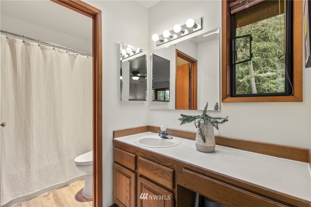 1060 Ridgewood Circle Southwest Issaquah, WA 98027 - Photo 21 of 38 a bathroom with a sink a vanity and a mirror