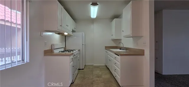 a kitchen with a stove and a refrigerator