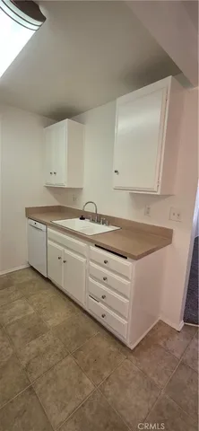 a kitchen with cabinets and white appliances