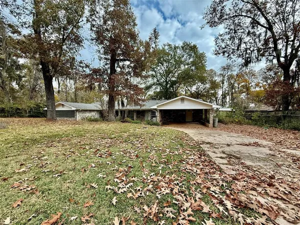 a wooden bench sitting in front of a house