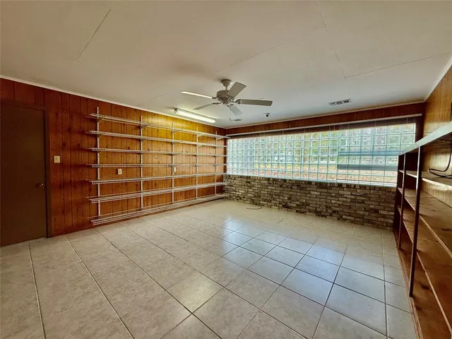 a view of empty room with cabinet and windows
