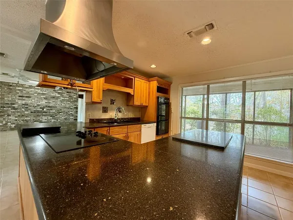 an empty room with windows and tables