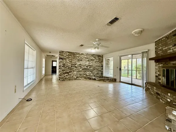 a view of a livingroom with a staircase and a ceiling fan
