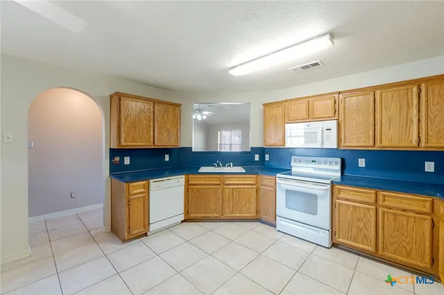 a kitchen with stainless steel appliances granite countertop a sink and cabinets
