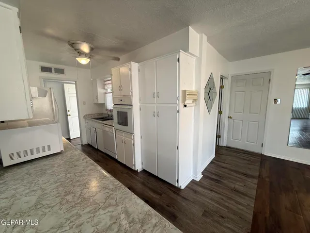 a kitchen with stainless steel appliances a refrigerator and a stove