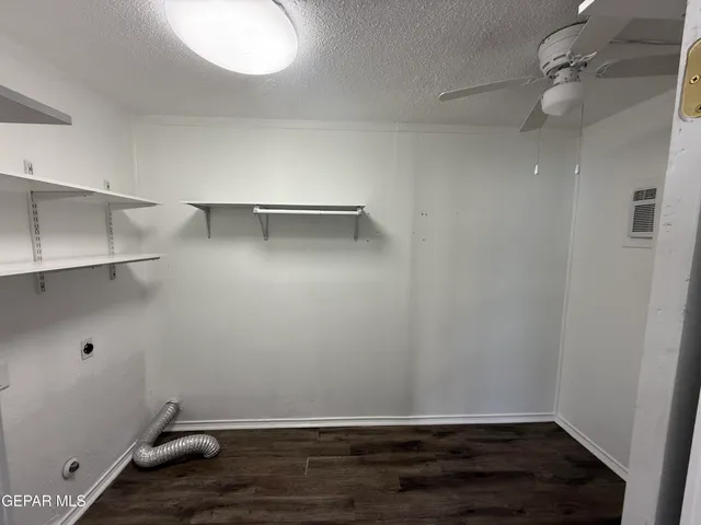 a view of room with cabinet and wooden floor