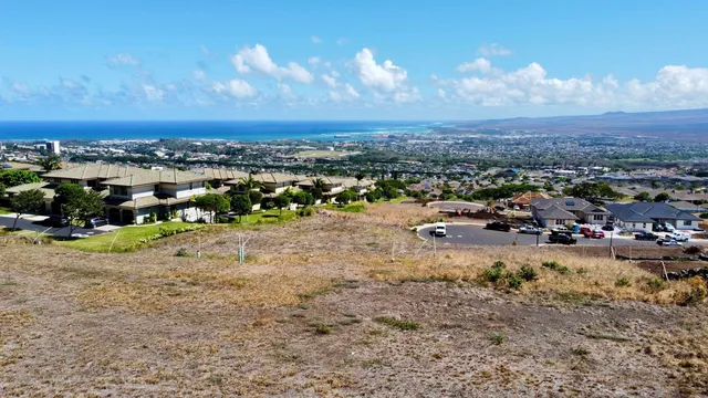 a view of a lake with multiple cars parked