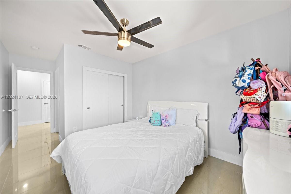 15341 Southwest 36th Street Miami, FL 33185 - Photo 35 of 56 a bedroom with a bed and a chandelier