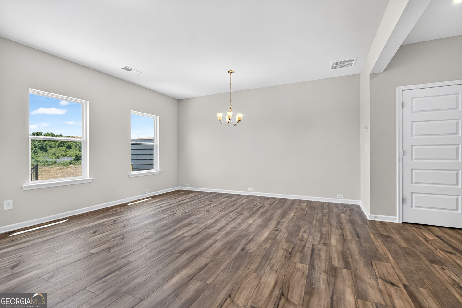 155 Oconee Road, Unit 252 Cartersville, GA 30120 - Photo 7 of 39 an empty room with wooden floor chandelier and windows