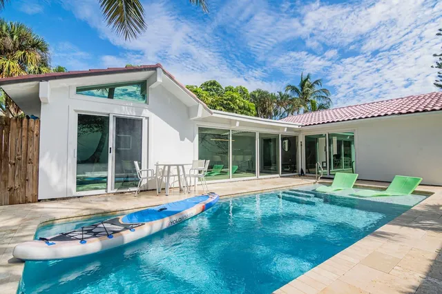 a view of a house with a yard and sitting area