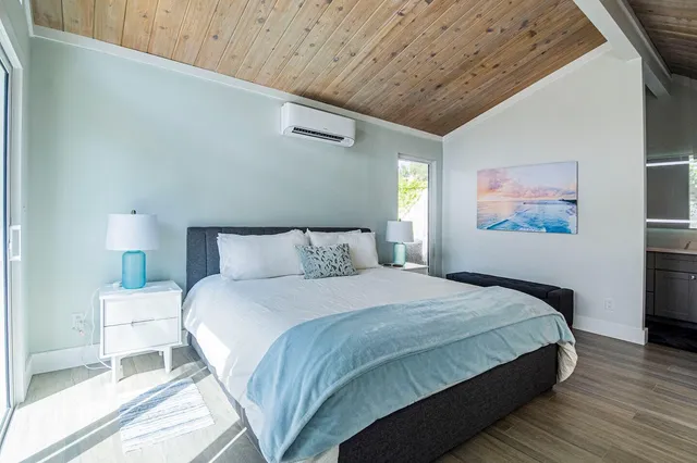 a bedroom with bed and a night stand