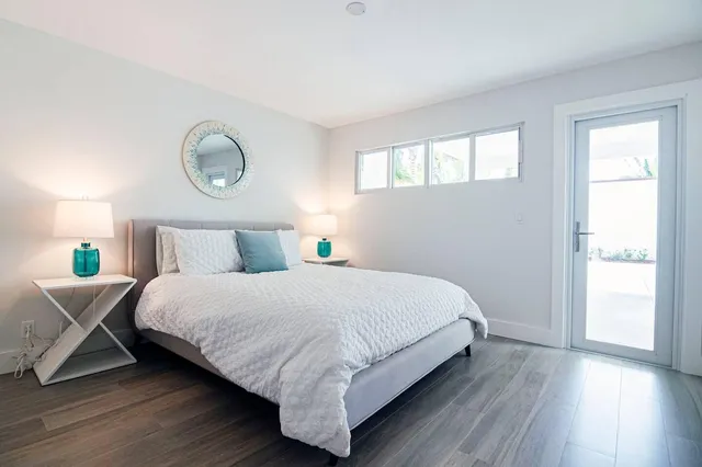 a bedroom with a bed and wooden floor