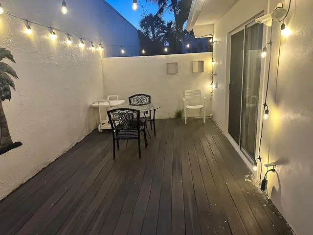 a view of a room with wooden floor and windows