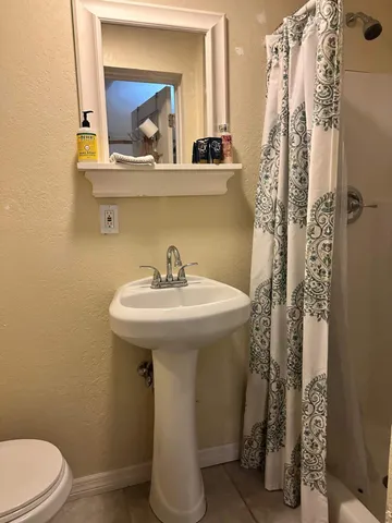 a bathroom with a sink a mirror and toilet