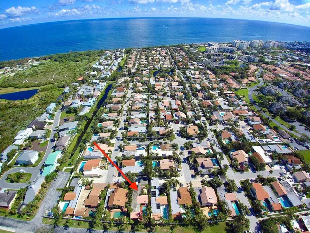 a view of sign board with flower in a yard