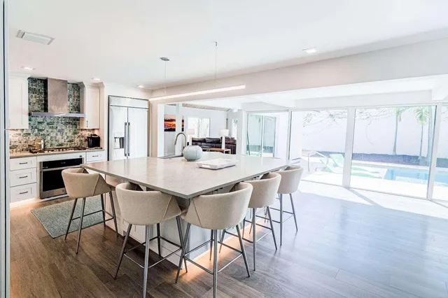 a dining room with furniture and wooden floor
