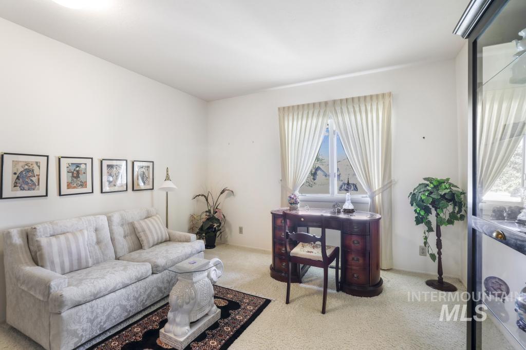 2018 Rancho Vista Drive Twin Falls, ID 83301 - Photo 32 of 50 Bright interior room featuring a window with white drapes, light-colored carpeting, and white walls