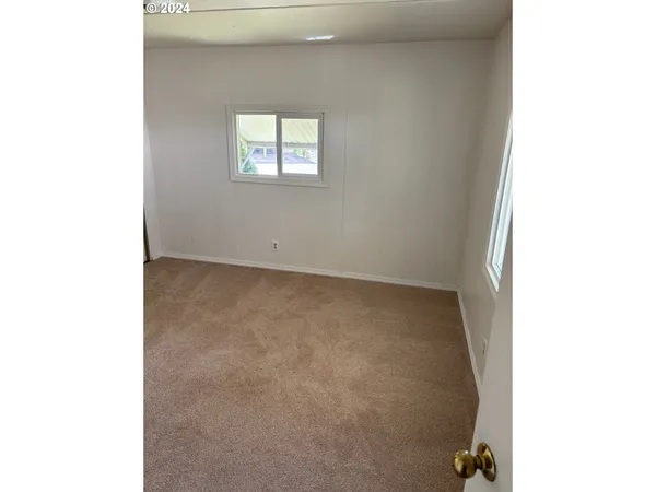 a view of an empty room with windows