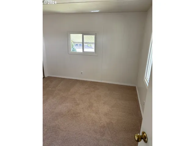 a view of an empty room with windows