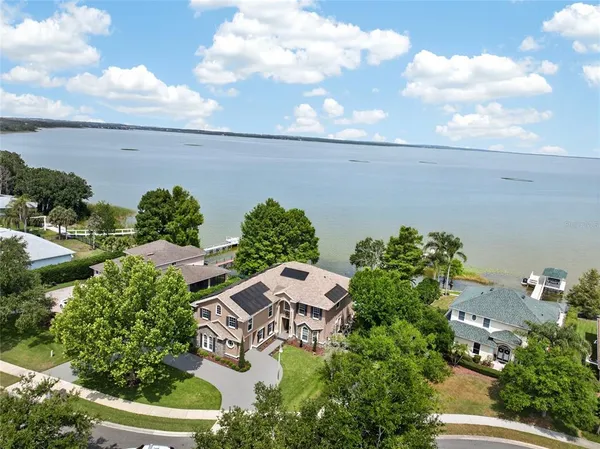 an aerial view of a house with lots of trees
