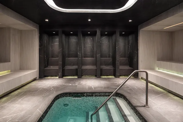 a room with a black car and a rug