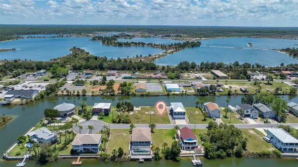 an aerial view of ocean and residential houses with outdoor space and lake view
