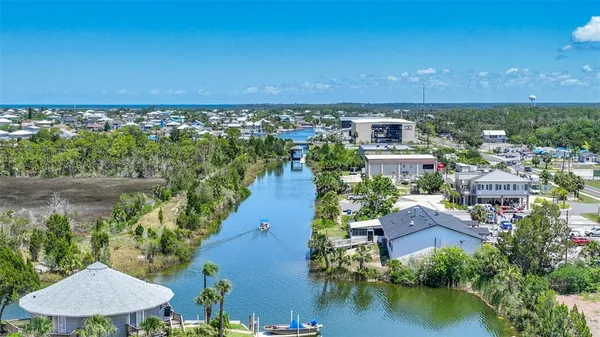 an aerial view of residential houses with outdoor space and lake view