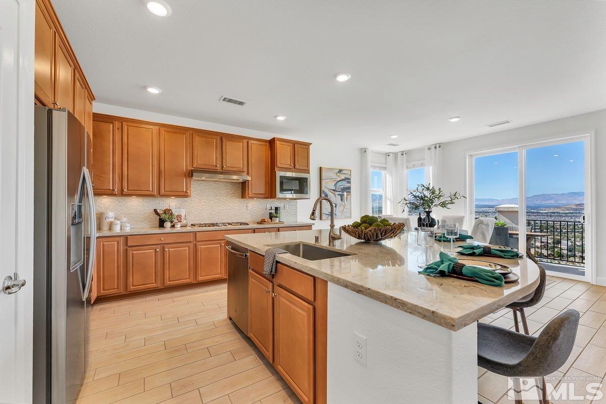 10537 Claim Jumper Way Reno, NV 89521 - Photo 12 of 40 a kitchen with a sink refrigerator and cabinets