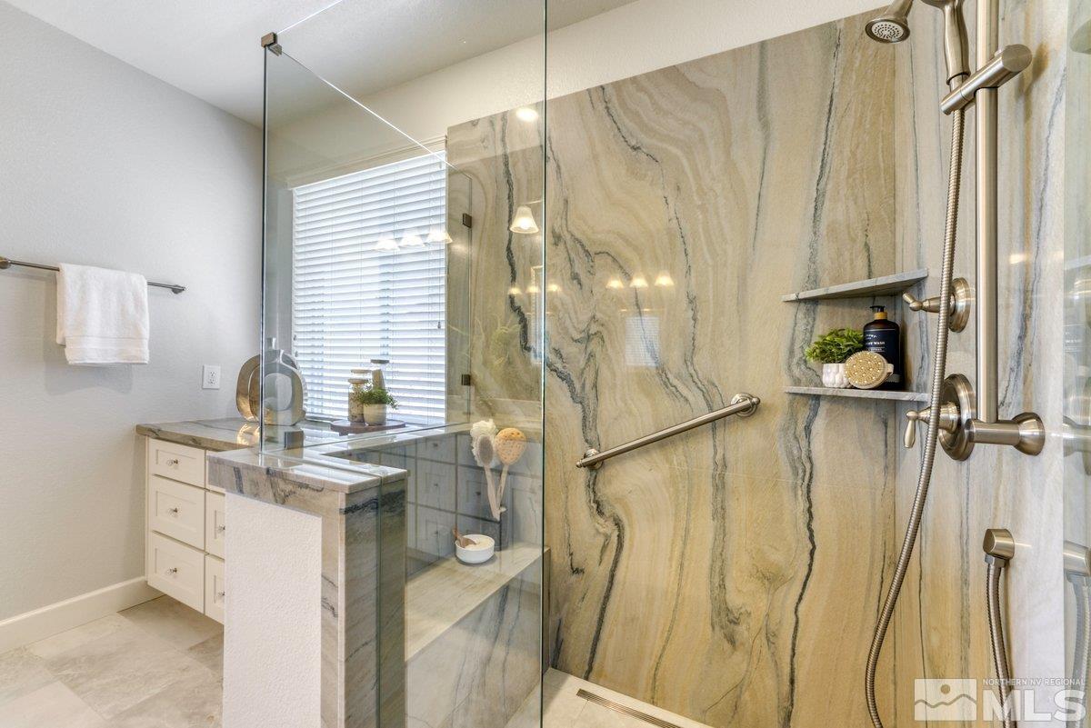 10537 Claim Jumper Way Reno, NV 89521 - Photo 21 of 40 a bathroom with a sink a mirror and shower