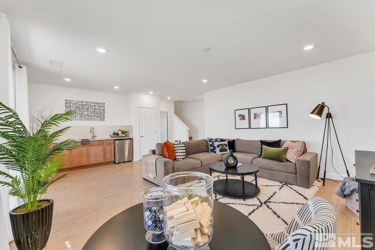 10537 Claim Jumper Way Reno, NV 89521 - Photo 24 of 40 a living room with furniture wooden floor and a potted plant