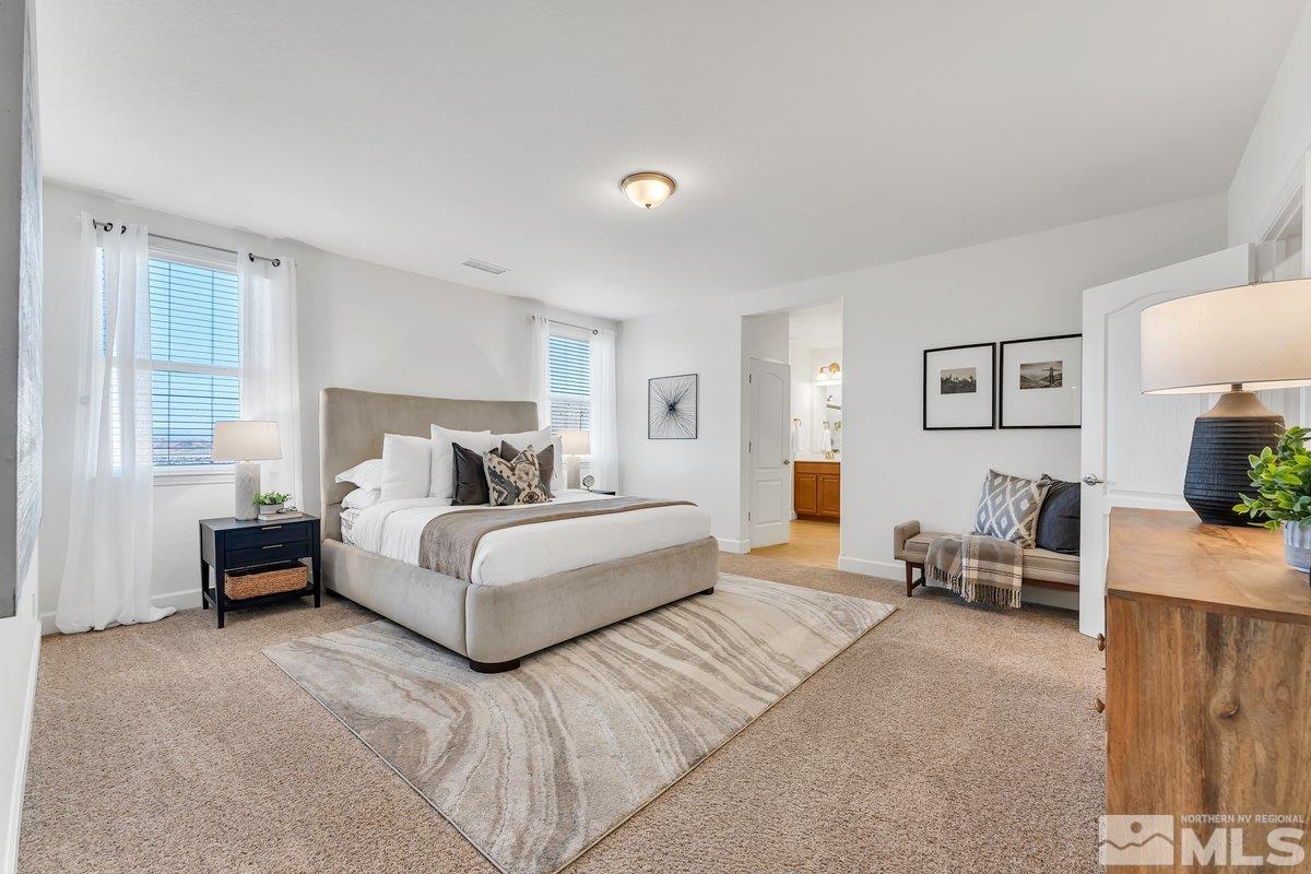 10537 Claim Jumper Way Reno, NV 89521 - Photo 26 of 40 a bedroom with a bed a couch and a window