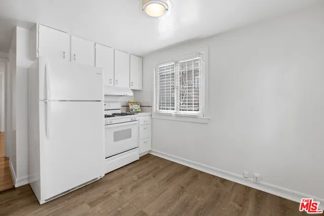 a white refrigerator freezer sitting inside of a kitchen