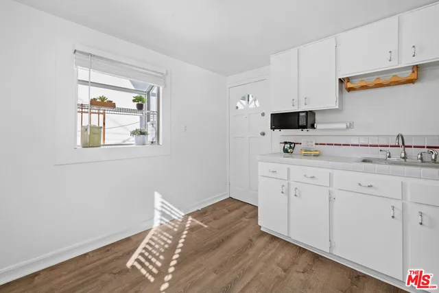 a kitchen with cabinets and window