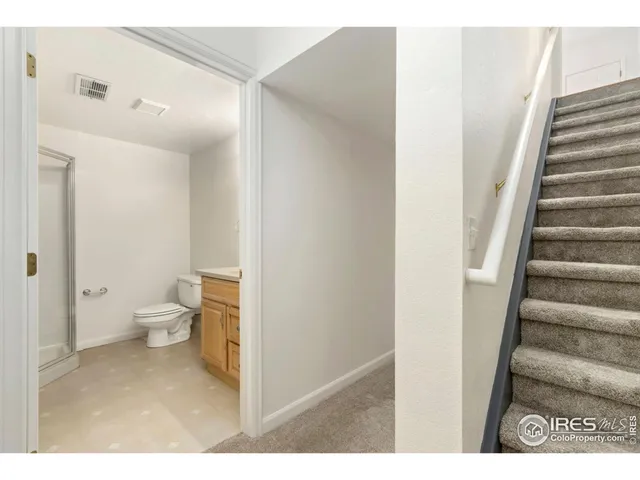 a bathroom with a sink a toilet a shower and a mirror