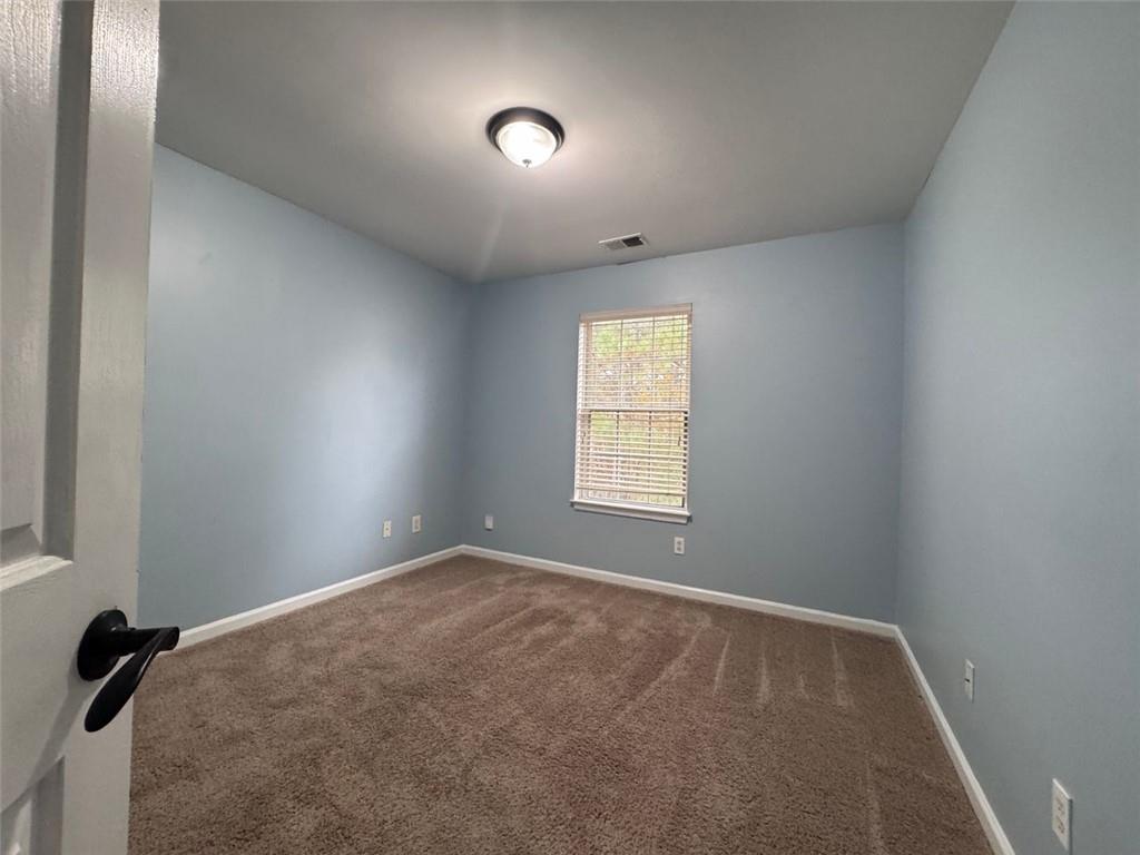 5495 Hampton Court Atlanta, GA 30349 - Photo 1 of 20 an empty room with windows