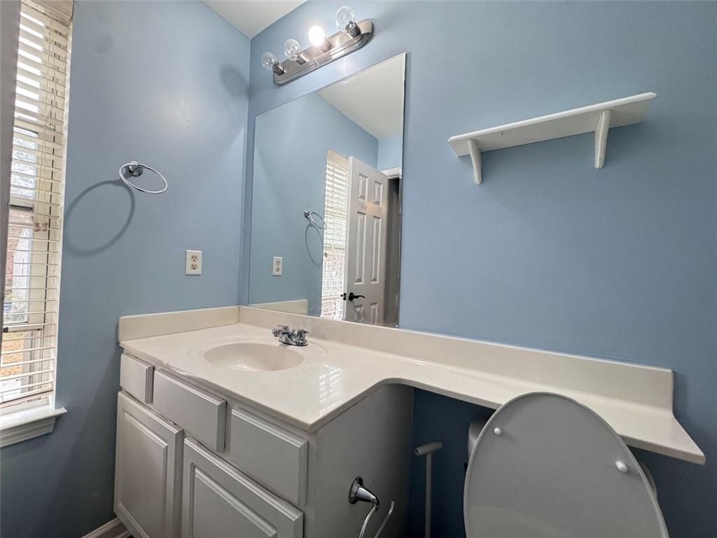 5495 Hampton Court Atlanta, GA 30349 - Photo 11 of 20 a bathroom with a sink and a mirror